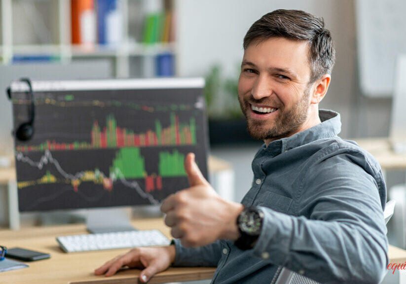 Happy mature businessman working on computer with economics statistics information, graphs and charts, sitting in office and showing thumb up. Corporate economic and financial data analysis